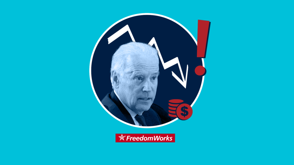 President Joe Biden in front of a downward trending graph.